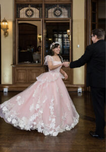 Bride and groom dancing in pink wedding dress